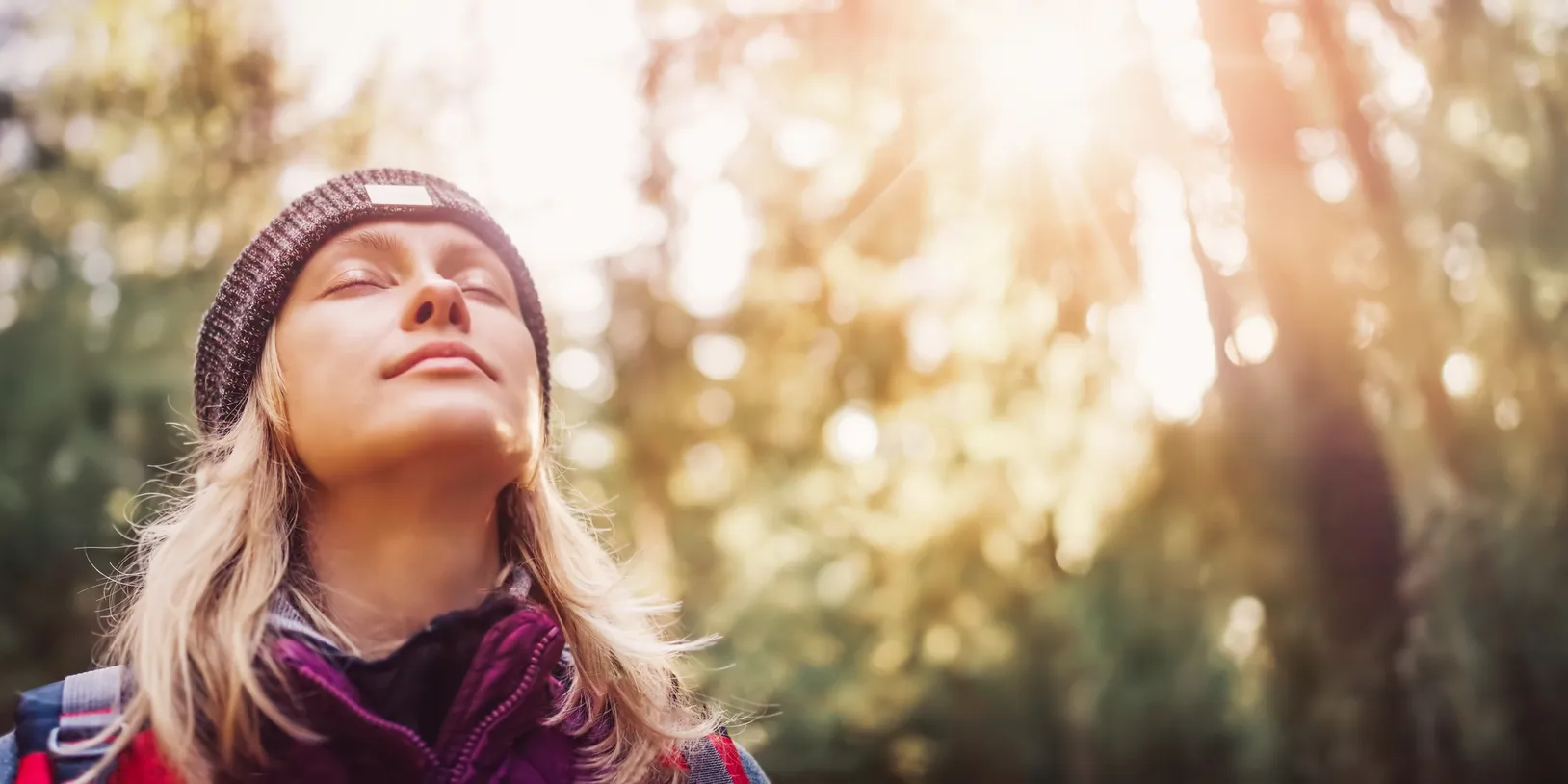 Woman enjoying a peaceful moment outdoors in nature.