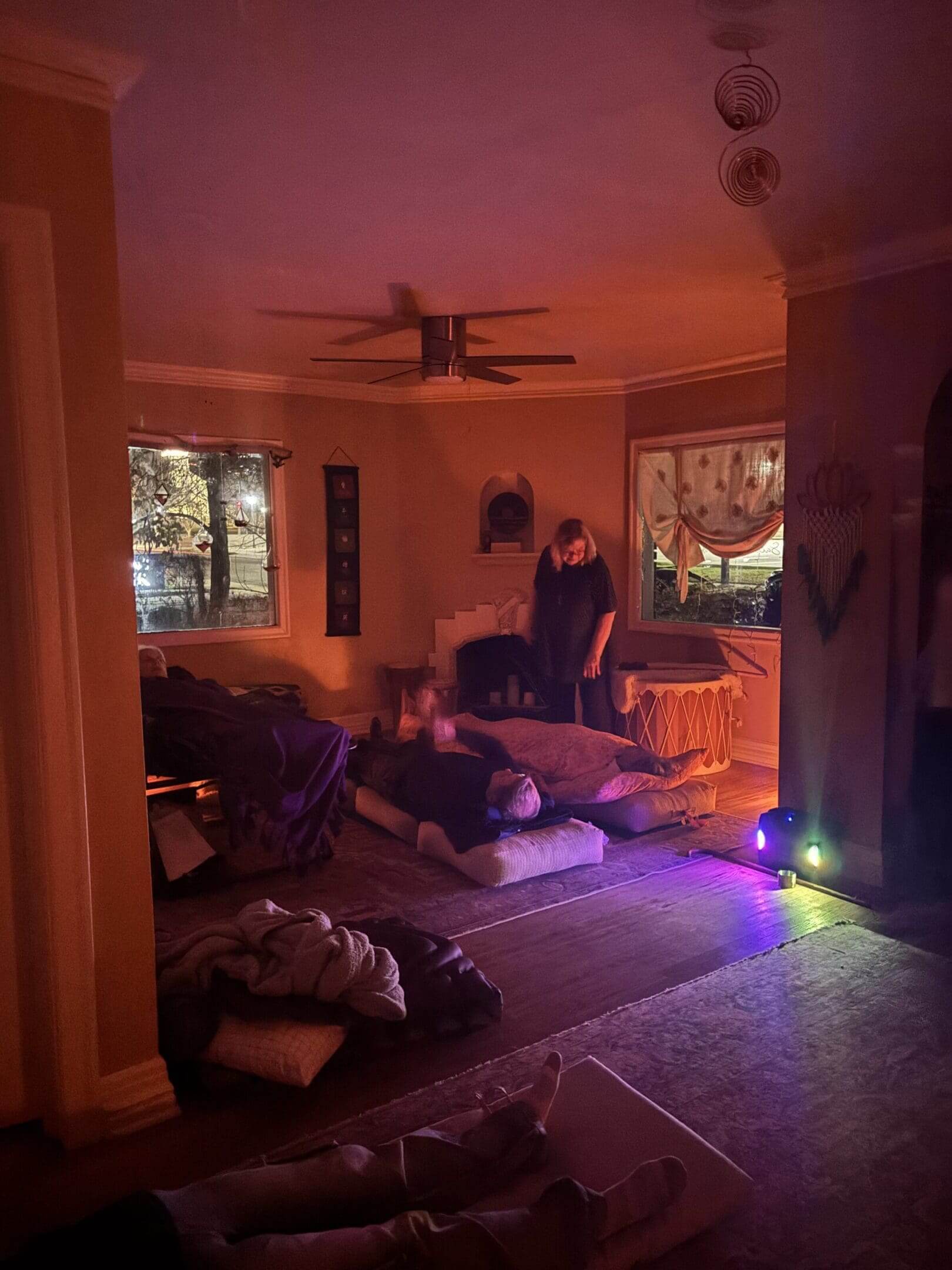 Dimly lit room with people resting.