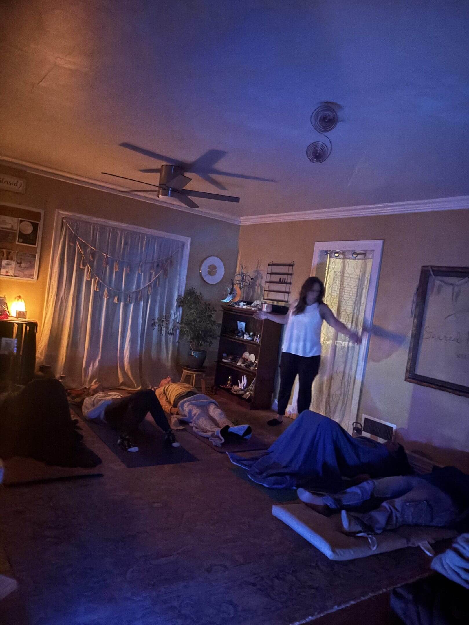 People relaxing in a dimly lit room.