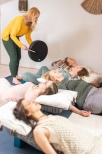 Yoga class with instructor and relaxing participants.